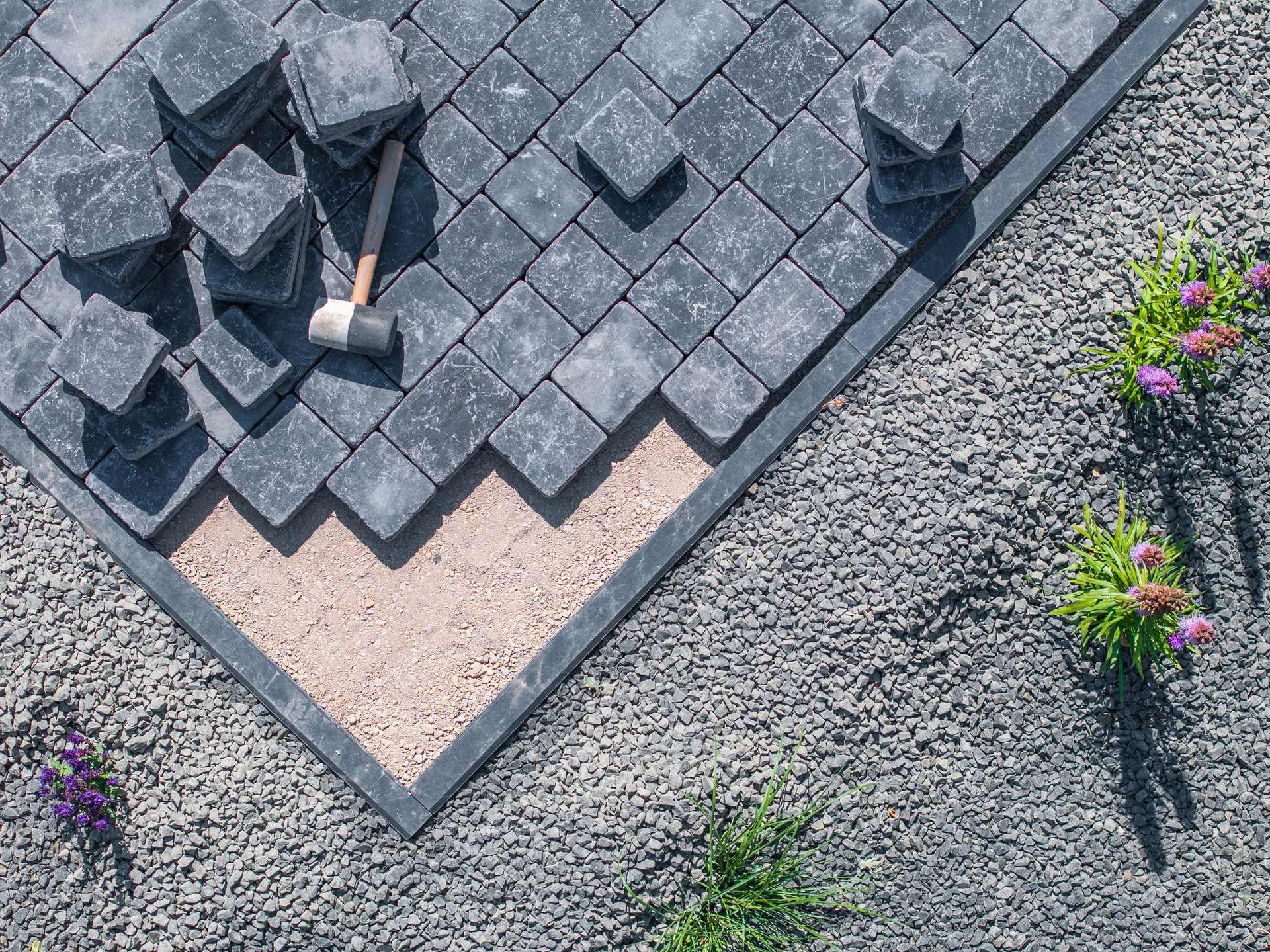 Laying Paving Stones in a Garden Pathway on a Sunny Day